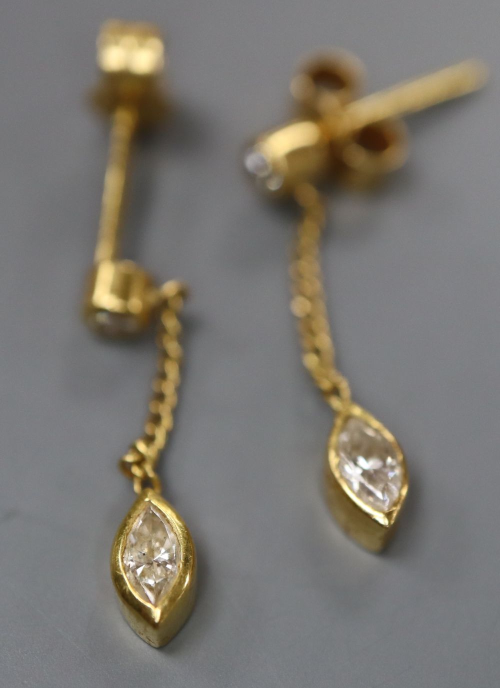 A modern pair of 18ct gold, marquise and round cut diamond set drop earrings, drop 22mm, gross 1.6 grams.